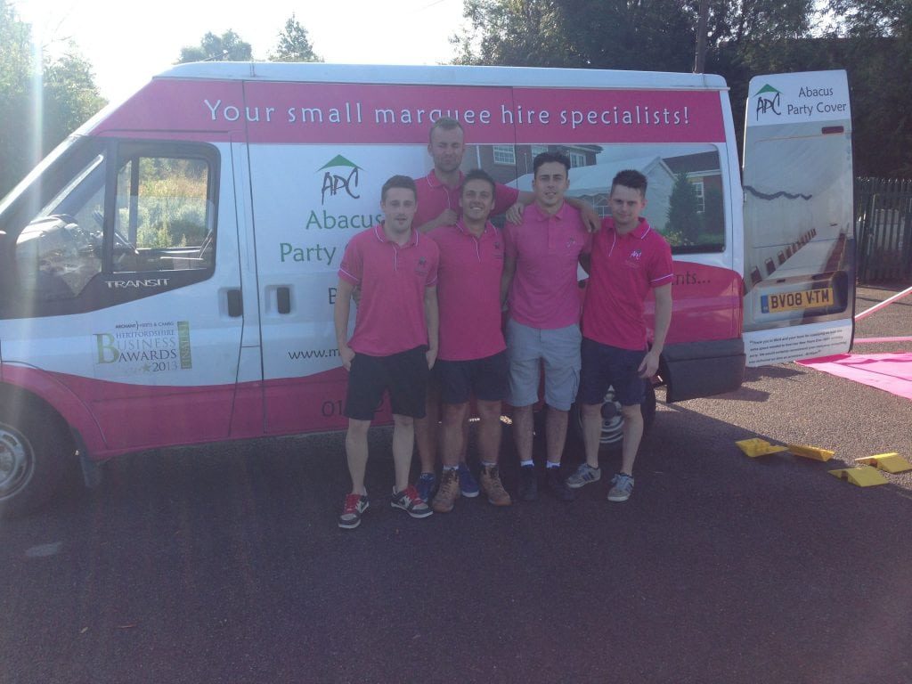 Abacus team in front of branded van